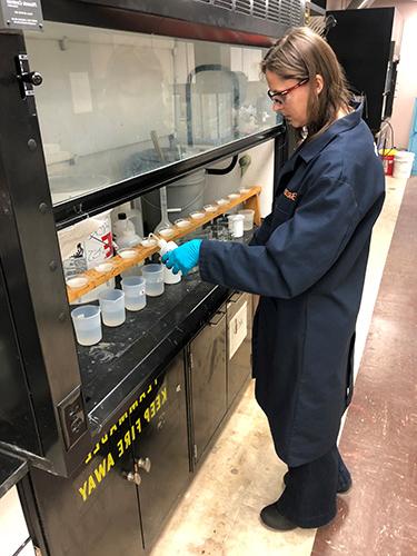 CAMP chemist Tina Stefanescu, conducting acid solubility testing of fracking sand (proppant) expressed as percent of undesirable (non-silica) contaminants.   2